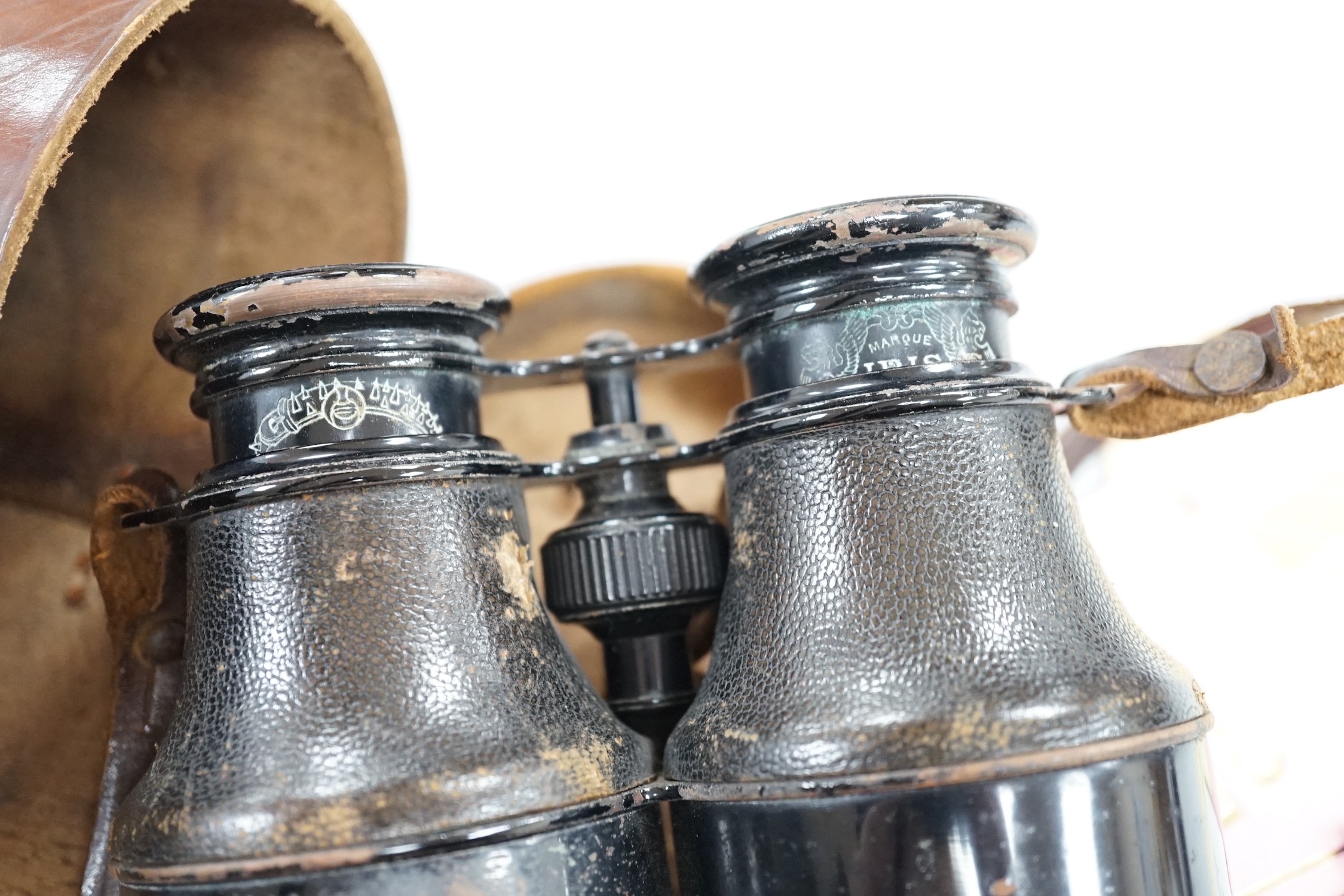 A pair of French binoculars in case, with various race meeting badges